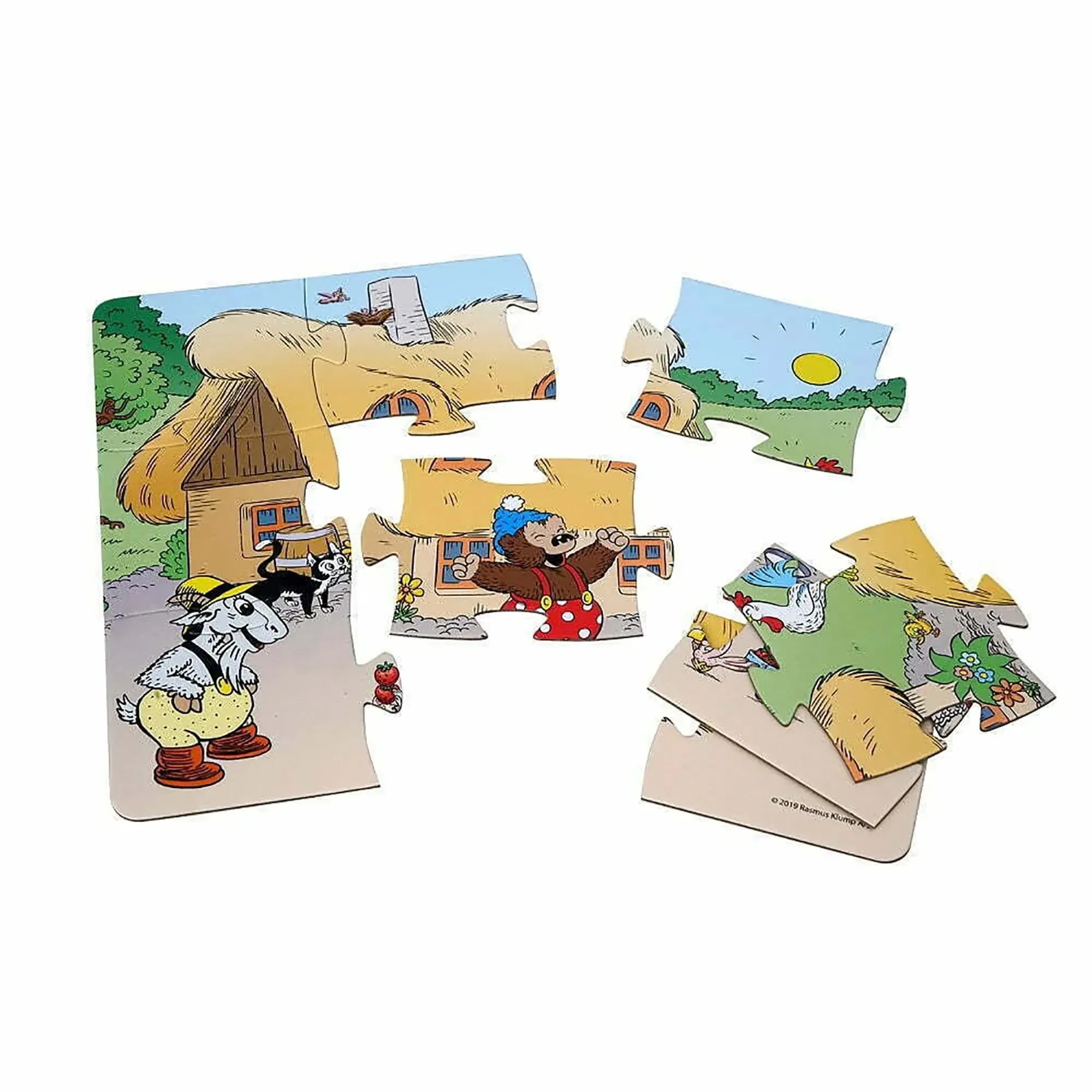 Close-up of large Rasmus Klump farm puzzle pieces showing colorful illustrations of farm life, including animals, a farmhouse, and Rasmus Klump. Perfect children's puzzle for learning and play.