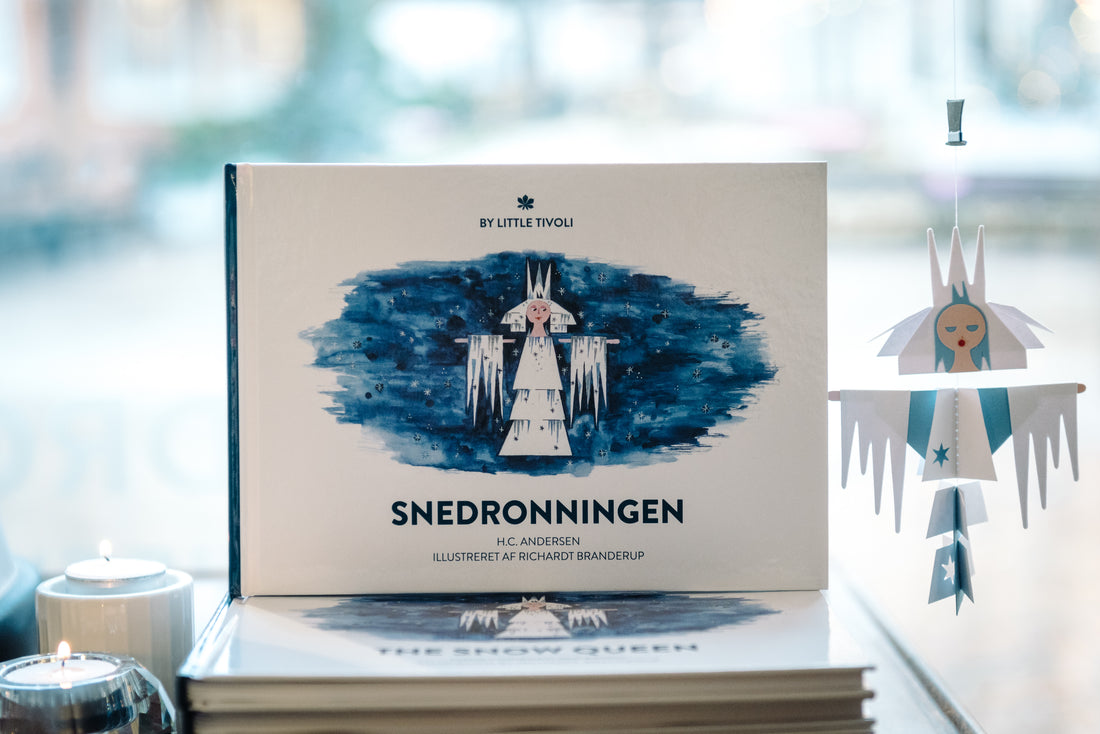Book cover of The Snow Queen by Hans Christian Andersen, illustrated by Richardt Branderup, featuring the Snow Queen surrounded by icy details on a dark blue background.