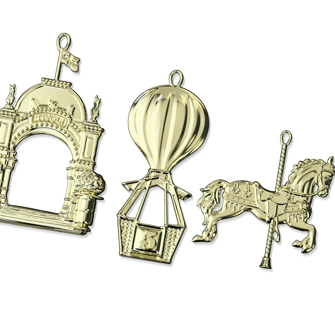 Tivoli x Karen Blixens Jul juleophæng i guldfarvet metal med motiver af Tivolis Hovedindgang, Ballongyngen og den ikoniske karusselhest. De detaljerede ornamenter er designet til juletræ, vinduesdekoration eller julekrans.