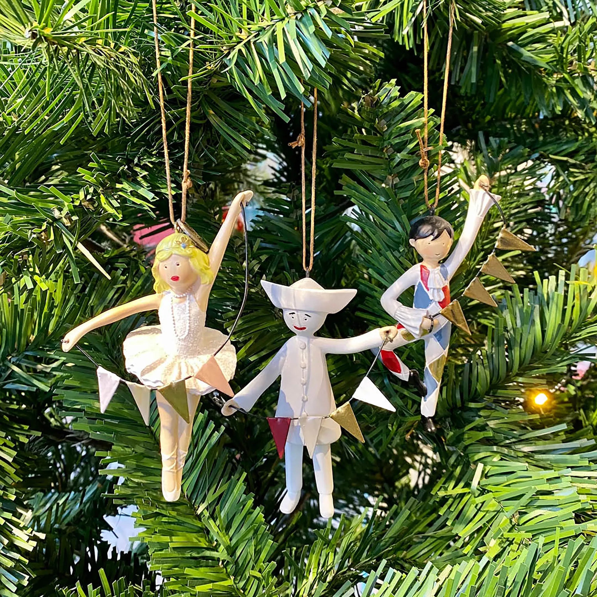 Decorative Tivoli Pantomime Christmas ornaments featuring Harlequin, Columbine and Pierrot displayed on a Christmas tree